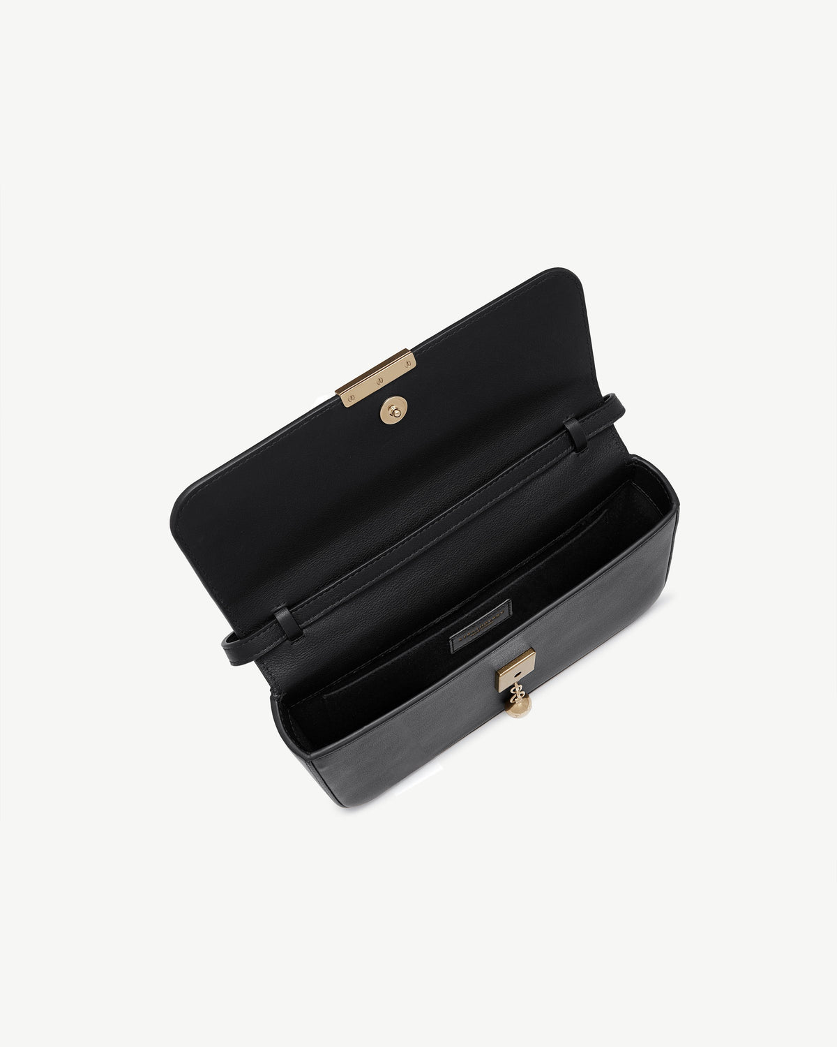 Black clutch open, showing interior compartments and gold push-lock clasp.
