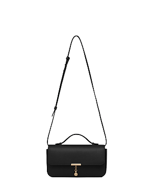 Black Nocturn clutch with top handle, adjustable shoulder strap, gold-tone hardware.