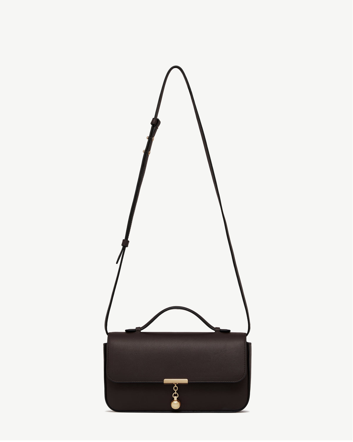 Espresso leather Nocturn clutch with top handle, long strap and gold charm.