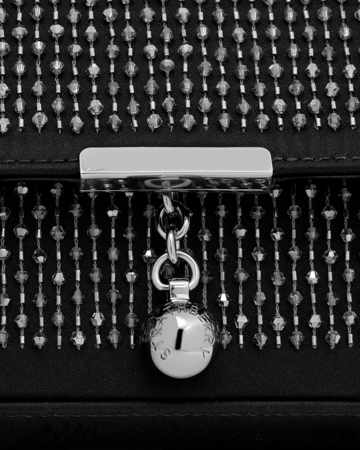 Black embroidered satin clutch with crystal rows and Strathberry silver clasp detail.